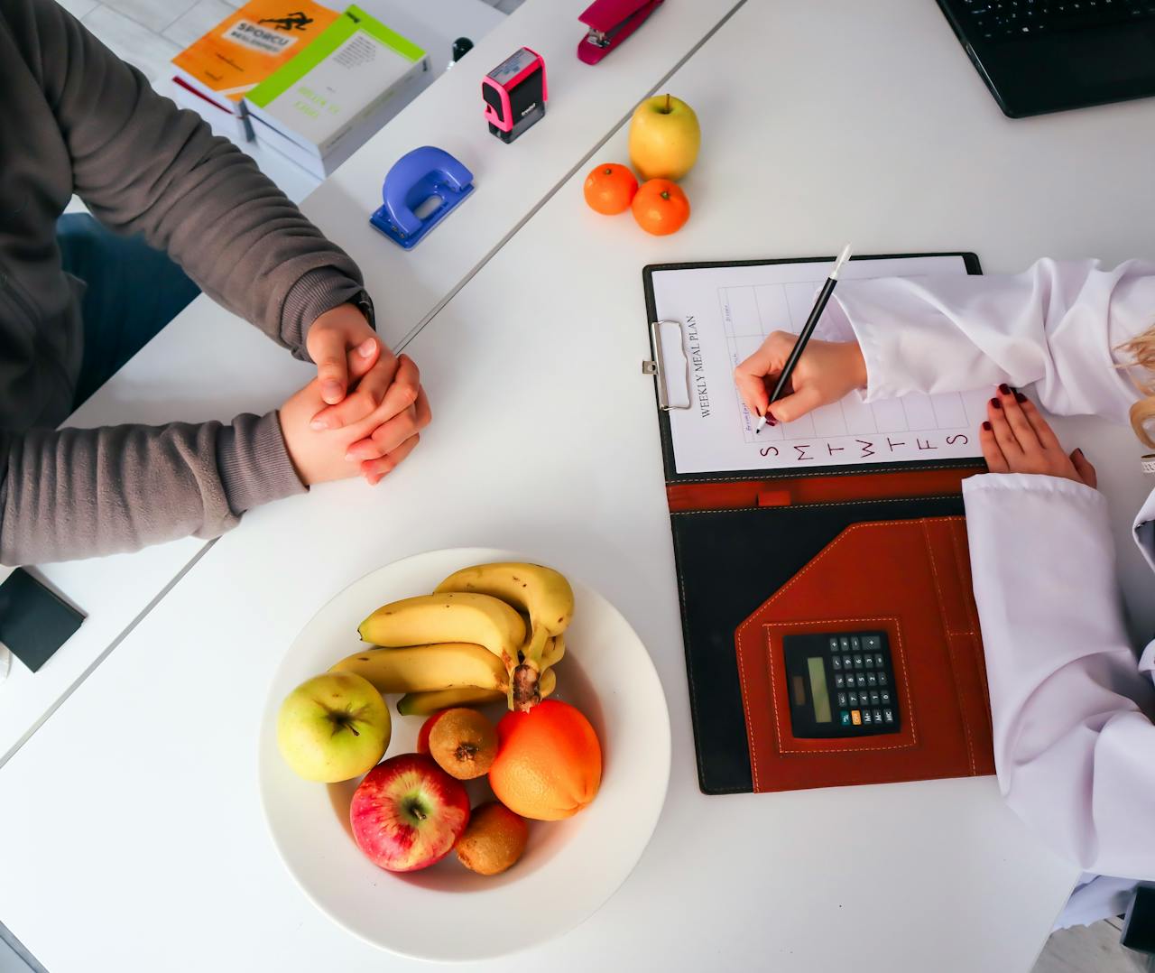 about-img Top view of a dietitian planning a healthy diet with fresh fruits on the table, focusing on health and nutrition.